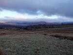 From the road across Birker Moor, the higher mountain tops  are covered by cloud.