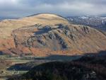 Buckbarrow in the sun with the whaleback of Seatallan beyond.