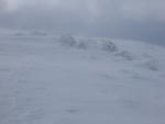 Approaching the summit of Raise and the air is white with spindrift.