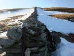 What appeared from below as a cairn on the summit is a wall  leading upwards.