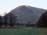 Red Screes lit by the sun behind Middle Dodd.