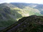 Sunlit ridges of Dollywagon Pike and Nethermost Pike with Striding Edge in the distance.
