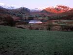 Early sun on Blake Fell beyond Little Langdale Tarn.