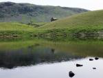 The abandoned fishing lodge across the tarn.
